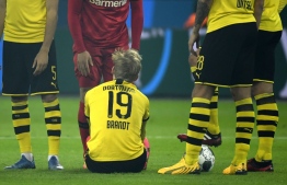 Dortmund's German forward Julian Brandt sits on the field after injury during the German first division Bundesliga football match Bayer 04 Leverkusen vs BVB Borussia Dortmund in Leverkusen, western Germany on February 8, 2020. (Photo by INA FASSBENDER / AFP) / RESTRICTIONS: DFL REGULATIONS PROHIBIT ANY USE OF PHOTOGRAPHS AS IMAGE SEQUENCES AND/OR QUASI-VIDEO