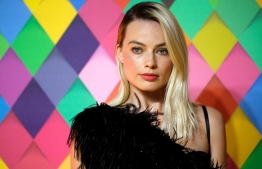 (FILES) In this file photo taken on January 29, 2020 Australian actor Margot Robbie poses on the red carpet upon arrival for the World Premiere of the film 'Birds of Prey' in London. - For Warner Bros.' new  release "Birds of Prey," the weekend brought good and bad news: It took in an estimated $33.3 million to lead the North American box office, but fared poorly for a superhero movie.The three-day estimate, from industry watcher Exhibitor Relations, marked one of the lowest domestic launches in years for a studio superhero film, according to Hollywood Reporter. The film, starring Margot Robbie as former Joker girlfriend Harley Quinn, has drawn generally strong reviews. Young Chinese-American director Cathy Yan won a special Sundance award for her debut film, dark comedy "Dead Pigs." (Photo by Tolga AKMEN / AFP)