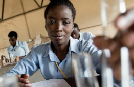 An adolescent girl conducts an experiment during a chemistry class in Kamulanga Secondary School in Lusaka, Zambia. PHOTO: KARIN SCHERMBRUCKER / UNICEF / UNITED NATIONS