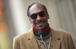 (FILES) In this file photo taken on November 19, 2018 Rapper Snoop Dogg attends the ceremony honoring him with a Star on Hollywood Walk of Fame, in Hollywood, California. - Rapper Snoop Dogg apologized on February 13, 2020 for an obscenity-laced tirade in which he appeared to threaten a CBS news anchor over an interview about late basketball star Kobe Bryant. Snoop Dogg's harangue on social media had followed an interview that "CBS This Morning" anchor Gayle King had with former women's basketball star Lisa Leslie which referenced a 2003 sexual abuse allegation against Bryant. (Photo by VALERIE MACON / AFP)