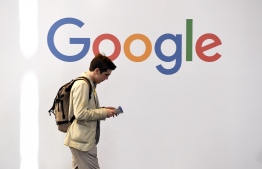 (FILES) In this file photo taken on May 24, 2018 a man walks past the logo of the US multinational technology company Google during the VivaTech trade fair ( Viva Technology), in Paris. - Google is in discussions on deals to pay media organizations for content, a move aimed at blunting criticism that it unfairly profits from copyrighted news, according to people familiar with the talks. Contacted by AFP on February 14, 2020, Google indicated it is seeking new ways to help publishers. Negotiations between the internet giant and news outlets were said to be in the early stages, with most of the publishers located in France and other parts of Europe. (Photo by ALAIN JOCARD / AFP)