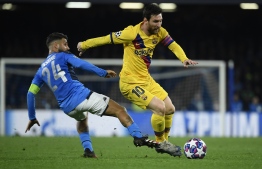 Barcelona's Argentine forward Lionel Messi (R) vies for the ball with Napoli's Italian forward Lorenzo Insigne during the UEFA Champions League round of 16 first-leg football match between SSC Napoli and FC Barcelona at the San Paolo Stadium in Naples on February 25, 2020. PHOTO: AFP
