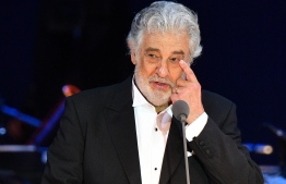 (FILES) In this file photo taken on August 28, 2019 Spanish tenor Placido Domingo gestures as he performs during his concert in the newly inaugurated sports and culture centre 'St Gellert Forum' in Szeged, southern Hungary. - Opera star Placido Domingo, who is facing multiple allegations of sexual harassment, on February 25, 2020 apologised for "the hurt" caused to his accusers, saying he accepted "full responsibility" for his actions. (Photo by Attila KISBENEDEK / AFP)