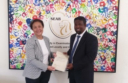 A SEAB official presenting the accreditation to Managing Director of Qualitet Education Moosa Rasheed. PHOTO: BRIGHTWAY ACHOOL