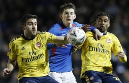 Arsenal's Greek defender Sokratis Papastathopoulos (L) and Arsenal's English midfielder Reiss Nelson (R) tangle with Portsmouth's English defender Steve Seddon (C) during the English FA Cup fifth round football match between Portsmouth and Arsenal at Fratton Park stadium in Portsmouth, southern England, on March 2, 2020. PHOTO: ADRIAN DENNIS / AFP