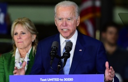 Democratic presidential hopeful former Vice President Joe Biden, flanked by his wife Jill, addresses a Super Tuesday event in Los Angeles on March 3, 2020. (Photo by FREDERIC J. BROWN / AFP)