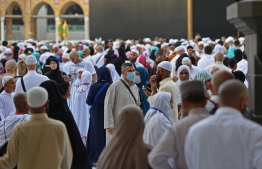 Muslim pilgrims wear masks at the Grand Mosque in Saudi Arabia's holy city of Mecca on February 28, 2020. - Saudi Arabia suspended visas for visits to Islam's holiest sites for the "umrah" pilgrimage, an unprecedented move triggered by coronavirus fears that raises questions over the annual hajj. The kingdom, which hosts millions of pilgrims every year in the cities of Mecca and Medina, also suspended visas for tourists from countries with reported infections as fears of a pandemic deepen. (Photo by Abdel Ghani BASHIR / AFP)