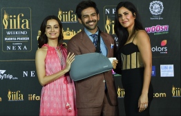 Bollywood actors Dia Mirza (L), Katrina Kaif (R) and Kartik Aaryan pose for pictures as they attend the International Indian Film Academy (IIFA) press Conference for the 21st Edition of NEXA IIFA Weekend & Awards 2020, in Mumbai on March 4, 2020. (Photo by INDRANIL MUKHERJEE / AFP)