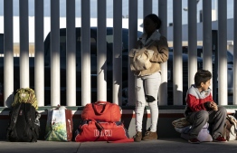 Asylum seekers wait for their turn to cross  to the United States at El Chaparral crossing port on the US/Mexico Border in Tijuana, Baja California state, Mexico, on February 29, 2020. . - Migrant Protection Protocols, better known as the 'Remain in Mexico Policy', was blocked by the United States Court of Appeals for the Ninth Circuit, seeming to halt a policy which drastically reduced the amount of border crossings. However, the court later granted the Trump Administration a stay on the program, for fear of creating an influx on the southern border (Photo by Guillermo Arias / AFP)