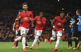 Manchester United's Portuguese midfielder Bruno Fernandes celebrates scoring his team's first goal during the UEFA Europa League round of 32 second leg football match between Manchester United and Club Brugge at Old Trafford in Manchester, north west England, on February 27, 2020. PHOTO: OLI SCARFF / AFP