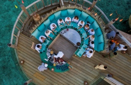 Overhead view of diners enjoying a meal at the restaurant 'So Bespoke' at Soneva Fushi. PHOTO/SONEVA