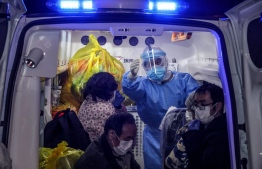 Infected patients leave Wuhan No.5 Hospital for Leishenshan Hospital, the new hospital for Covid-19, in Wuhan, China on March 3. SOURCE: AFP