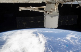 This NASA photo obtained March 10, 2020 shows the SpaceX Dragon resupply ship attached to the International Space Station's Harmony module as both spacecraft were soaring 265 miles above the Atlantic coast of Brazil on March 9, 2020. (Photo by Handout / NASA / AFP) / 