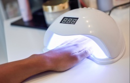 Hand placed in UV Lamp, often utilised for manicures and pedicures.  IMAGE: STOCK PHOTOS