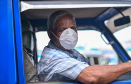 Malé, March 19, 2020: A pick-up driver pictured wearing a face mask. Many are seen wearing the mask as a precaution against COVID-19. PHOTO: AHMED AWSHAN