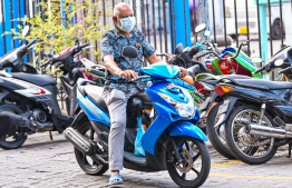 Malé, March 19, 2020: Many residents of Malé city are seen wearing face masks on their motorcycles as a precautionary measure against COVID-19. PHOTO: AHMED AWSHAN