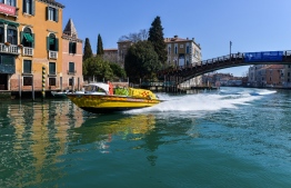 An ambulance speedboat sails a canal in Venice on March 18, 2020, during the country's lockdown within the new coronavirus crisis. (Photo by ANDREA PATTARO / AFP)