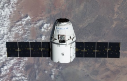 This NASA photo obtained March 10, 2020 shows the SpaceX Dragon resupply ship approaching the International Space Station as both spacecraft were soaring 267 miles above the African nation of Namibia on March 9, 2020. (Photo by Handout / NASA / AFP) / 