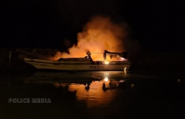 The police speedboat set on fire while docked at the harbour of Gan, Laamu Atoll on March 22. PHOTO: POLICE