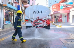An MNDF Firefighter observes and directs the cleansing of the streets of Male'. The event took place prior to the first incidence of a person within the city's own community confirming positive for COVID-19. PHOTO: AHMED AWSHAN ILYAS / MIHAARU
