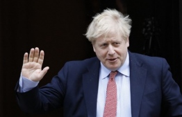(FILES) In this file photo taken on March 25, 2020 Britain's Prime Minister Boris Johnson leaves number 10 Downing Street in central London on March 18, 2020, on his way to the House of Commons to attend Prime Minister's Questions (PMQs) - Britain's Prime Minister Boris Johnson has tested positive for the new coronavirus COVID-19 and is self-isolating in 10 Downing Street, it was announced on March 27, 2020. Johnson experienced "mild symptoms" on March 26 and was tested at Number 10 by NHS staff, a statement said. (Photo by Tolga AKMEN / AFP)