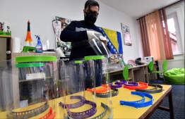 A mechanical engineering student assemble protective masks as a precaution against the Covid-19, with some parts made with 3D printers at "IDEA LAB", in Zenica, on March 25, 2020. - A group of students and professors from the University of Zenica, a small town in central Bosnia, make protective masks, using 3D printing technology, for medical personnel, on the front line in the fight against the novel coronavirus. More specifically, these are face shields, parts of which are made using 3D printing. Some 170 people have been infected in Bosnia with the new coronavirus. Covid-19 disease has killed three people in this country of 3.5 million people. (Photo by ELVIS BARUKCIC / AFP)