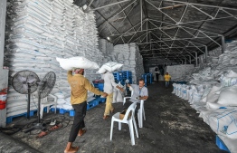 The photograph depicts the State Trade Organization's imported stock of rice and staples, at the beginning of the local outbreak of COVID-19.  PHOTO: MIHAARU