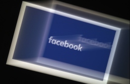 In this photo illustration a Facebook App logo is displayed on a smartphone on March 25, 2020 in Arlington, Virginia. (Photo by Olivier DOULIERY / AFP)