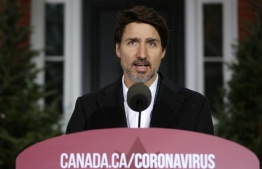 (FILES) In this file photo taken on March 29, 2020 Canadian Prime Minister Justin Trudeau speaks during a news conference on COVID-19 situation in Canada from his residence in Ottawa, Canada. - Canadians must be vigilant for at least a year, the time it may take for a coronavirus vaccine to become available, Justin Trudeau warned on April 9, 2020, as his government projected the disease could kill 11,000-22,000 people there.
"The path we take is up to us," the Canadian prime minister said at his daily press conference, shortly after the release of the first national projections on the evolution of the pandemic in Canada. (Photo by Dave Chan / AFP)