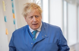 (FILES) In this file photo taken on March 06, 2020 Britain's Prime Minister Boris Johnson visits to the Mologic Laboratory in the Bedford technology Park, north of London . - Britain's Prime Minister Boris Johnson appeared to be on the road to recovery as Downing Street said the Prime Minister had returned to the ward at St Thomas' Hospital after spending three nights in the intensive care unit. (Photo by Jack Hill / POOL / AFP)