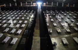 Bombay Municipal Corporation workers prepare an isolation centre at the NSCI dome during a government-imposed nationwide lockdown as a preventive measure against the COVID-19 coronavirus, in Mumbai on April 9, 2020. (Photo by Punit PARANJPE / AFP)