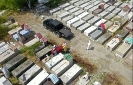 Aerial view of workers burying a coffin at Maria Canals cemetery in the outskirts of Guayaquil, Ecuador, on April 12, 2020, amid the new coronavirus outbreak. PHOTO: AFP
