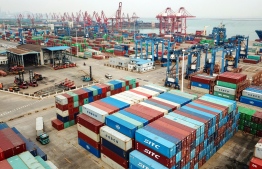 This aerial photo taken on April 14, 2020 shows containers stacked at a port in Lianyungang in China's eastern Jiangsu province. - China's foreign trade fell again in March even as businesses returned to work after the coronavirus outbreak, with the global pandemic weighing on the manufacturing powerhouse's outlook. (Photo by STR / AFP) / 