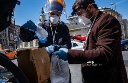 Members of The Tarlabasi Solidarity Network prepare aid packages of disinfectants, gloves, face masks as well as food cards for African migrants in Istanbul on April 17, 2020, during the COVID-19 pandemic, caused by the novel coronavirus. - Istanbul's African migrants are among the most vulnerable groups as the coronavirus pandemic hits Turkey's largest city. Some 80,000 -- most of them undocumented-- live in the city of about 15 million people where almost half of the nearly 80,000 coronavirus cases have been recorded. (Photo by Yasin AKGUL / AFP)