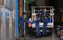 Police helping a family that urgently needed to move, during the lockdown imposed over Male' City on March 12. Presently, much restrictions have been lifted, although the country is slowly phasing out it's return to a new normalcy. PHOTO: MIHAARU