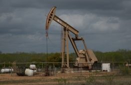 (FILES) In this file photo taken on March 12, 2019 a pump jack operates at an oil extraction site in Cotulla, Texas. - US crude crashed to below $15 a barrel on April 20, 2020, its lowest level for over two decades, as concerns about a virus-triggered demand shock and lack of storage eclipsed an output cut deal. (Photo by Loren ELLIOTT / AFP)
