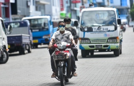 Citizens wearing face masks in the capital city of Male' which is currently locked down in response to a COVID-19 outbreak. PHOTO: AHMED AWSHAN ILYAS/ MIHAARU