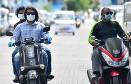 Men driving motorcycles in masks: work from home has been extended till May 22 by President Ibrahim Mohamed Solih -- Photo: Ahmed Awshan Ilyas/ Mihaaru