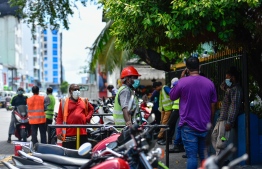 Workers are seen outside the Maldives Ports Limited. PHOTO: AHMED AWSHAN ILYAS / MIHAARU