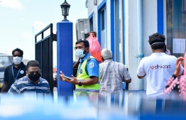 A patrol officer in public amidst the COVID-19 crisis in Malé area. Authorities are imposing fines and arresting those who violate lockdown orders. PHOTO: AHMED AWSHAN ILYAS/ MIHAARU