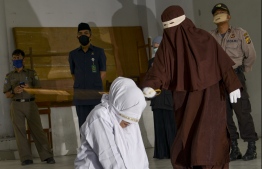 Indonesia's conservative Aceh province flogged six people on April 21 for violating Islamic law, pushing ahead with the common—and widely criticised—practice despite widespread bans on mass gatherings over coronavirus fears. PHOTO: AFP
