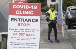 A security guard stands outside a COVID-19 coronavirus clinic in Lower Hutt, near Wellington, on April 20, 2020. (Photo by Marty MELVILLE / AFP)