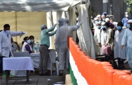 Medical officers conduct tests for patients suspected to be infected for the COVID19 virus. PHOTO: AFP