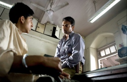 Khan as the police inspector, with Dev Patel in Slumdog Millionaire (2008. PHOTO: ALLSTAR/FILM4