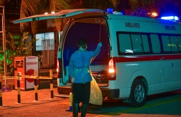 A man hoses down and disinfects an ambulance, during the lockdown in Male' City. FILE PHOTO/MIHAARU