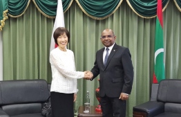 Minister of Foreign Affairs shaking hands with the representative of the Japanese government. Japan extended emergency grants for the Maldives' response to the COVID-19 outbreak. PHOTO: FOREIGN MINISTRY
