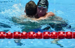 Russia's Anton Chupkov (L) reacts with USA's Andrew Wilson after winning and making a world record in the final of the men's 200m breaststroke event during the swimming competition at the 2019 World Championships at Nambu University Municipal Aquatics Center in Gwangju, South Korea, on July 26, 2019. (Photo by Ed JONES / AFP)