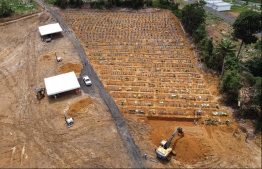 Aerial view of Nossa Senhora cemetery -where Brazilian Ulisses Xavier, 52, has worked for 16 years- in Manaus, Brazil, on May 7, 2020, amid the new coronavirus pandemic. - Xavier works 12 hours a day and supplements his income by making wooden crosses for graves. The cemetery has seen a surge in the number of new graves after the outbreak of COVID-19. PHOTO: MICHAEL DANTAS / AFP
