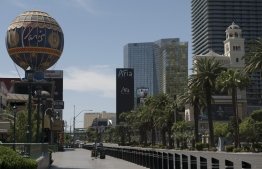 An empty Las Vegas Strip is seen amid the novel coronavirus pandemic on May 8, 2020 in Las Vegas, Nevada. - In the absence of bustling crowds of drunken revelers, packed poker tables and overzealous club promoters, the slogan "what happens in Vegas stays in Vegas" has never felt more redundant. Last year, May was Las Vegas's second-busiest month, drawing nearly 3.7 million visitors. Now, the sidewalks lie empty under the scorching sun, except for idle security guards, and a handful of vagrants and bewildered-looking tourists. (Photo by Bridget BENNETT / AFP)