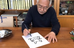 In this frame grab taken from undated handout video footage released by the Nagoya City Education Board Education Centre on May 12, 2020, Studio Ghibli producer Toshio Suzuki gives an online tutorial for drawing one of its characters 'Totoro' at his home in Tokyo. - Suzuki contributed the video to a website intended to support children stuck at home during the coronavirus outbreak. The lovable Totoro is the star of Studio Ghibli's popular film "My Neighbour Totoro", which tells the story of two sisters and their friendships with forest creatures. (Photo by Handout / NAGOYA CITY EDUCATION BOARD EDUCATION CENTRE / AFP) / RESTRICTED TO EDITORIAL USE - MANDATORY CREDIT "AFP PHOTO / NAGOYA CITY EDUCATION BOARD EDUCATION CENTRE" - NO MARKETING NO ADVERTISING CAMPAIGNS - DISTRIBUTED AS A SERVICE TO CLIENTS --- NO ARCHIVES ---